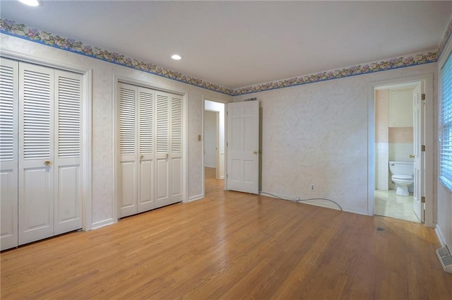 3913 Stonewall Ave, Independence, MO 64055 - unfurnished bedroom with recessed lighting, baseboards, multiple closets, ensuite bath, and light wood-style flooring