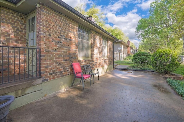 3913 Stonewall Ave, Independence, MO 64055 - view of home's exterior featuring a patio and brick siding