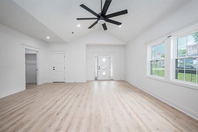 unfurnished living room featuring visible vents, light wood-style floors, baseboards, a ceiling fan, and vaulted ceiling
