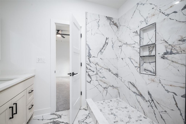 full bath featuring a ceiling fan, a marble finish shower, marble finish floor, and vanity