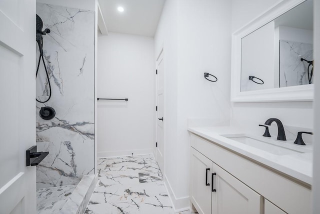 bathroom with baseboards, vanity, marble finish floor, a marble finish shower, and recessed lighting