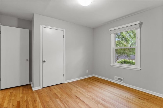 unfurnished bedroom with light wood-style floors and baseboards