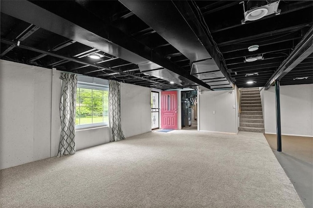 below grade area featuring stairs and carpet floors