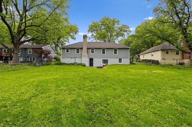 back of property with a chimney
