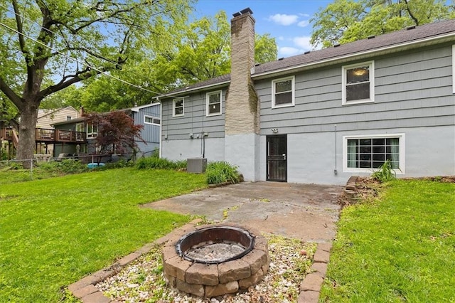 rear view of house featuring an outdoor fire pit, a chimney, and a patio