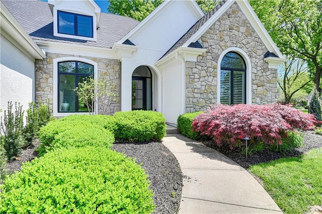 17045 S Highland Ridge Dr, Loch Lloyd, MO 64012 - view of exterior entry featuring stone siding and stucco siding