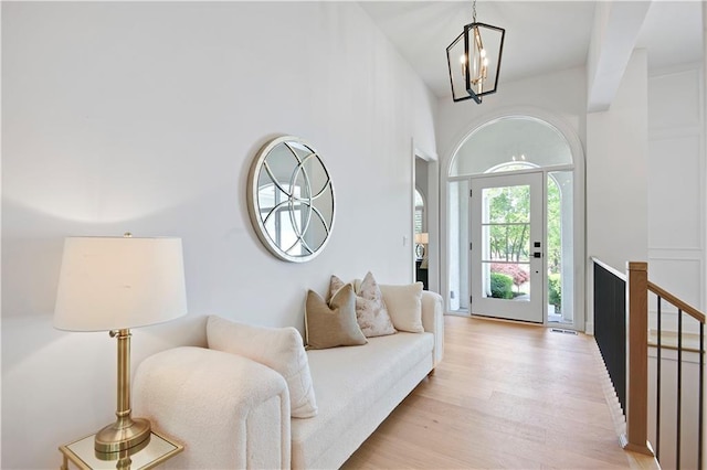 17045 S Highland Ridge Dr, Loch Lloyd, MO 64012 - living room featuring light wood-style flooring and a chandelier