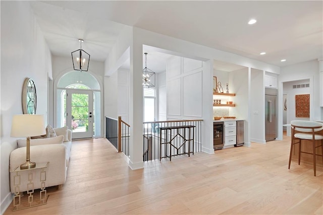 17045 S Highland Ridge Dr, Loch Lloyd, MO 64012 - hall featuring wine cooler, an upstairs landing, light wood finished floors, recessed lighting, and baseboards