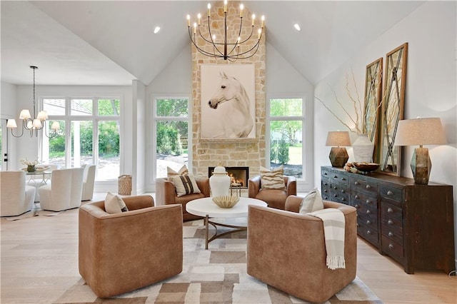 17045 S Highland Ridge Dr, Loch Lloyd, MO 64012 - sitting room with a chandelier, light wood finished floors, plenty of natural light, a stone fireplace, and high vaulted ceiling