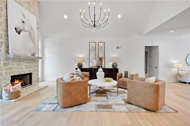 17045 S Highland Ridge Dr, Loch Lloyd, MO 64012 - living area featuring high vaulted ceiling, a chandelier, a stone fireplace, wood finished floors, and baseboards
