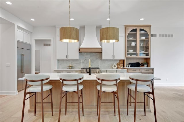 17045 S Highland Ridge Dr, Loch Lloyd, MO 64012 - kitchen with custom exhaust hood, built in fridge, tasteful backsplash, light countertops, and recessed lighting