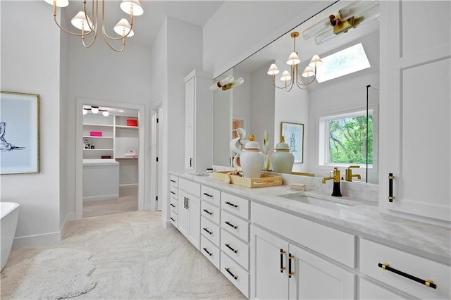 17045 S Highland Ridge Dr, Loch Lloyd, MO 64012 - full bath featuring a chandelier, a towering ceiling, double vanity, a soaking tub, and baseboards