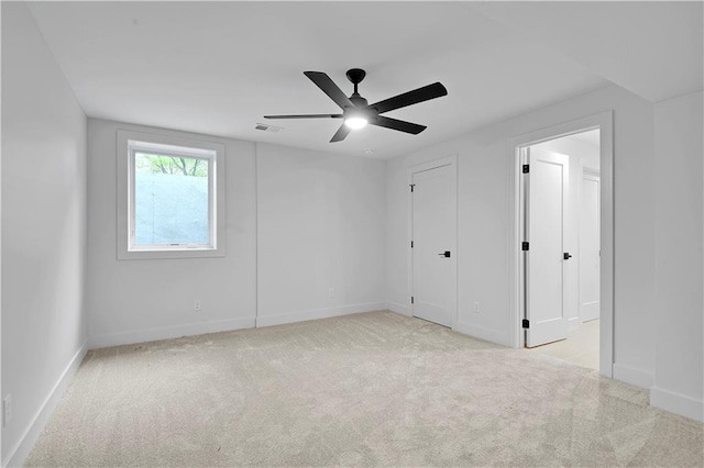 17045 S Highland Ridge Dr, Loch Lloyd, MO 64012 - unfurnished bedroom featuring light carpet, baseboards, and ceiling fan