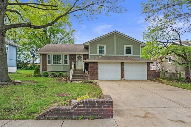 tri-level home featuring concrete driveway, brick siding, an attached garage, and a front lawn