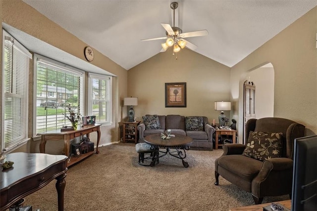 living room with arched walkways, ceiling fan, carpet flooring, and lofted ceiling