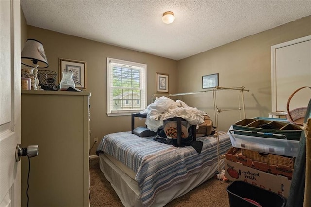 bedroom featuring carpet flooring and a textured ceiling