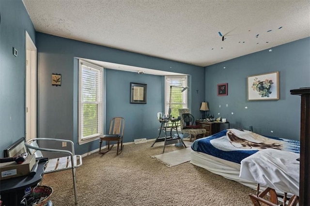 carpeted bedroom with baseboards, a textured ceiling, and visible vents