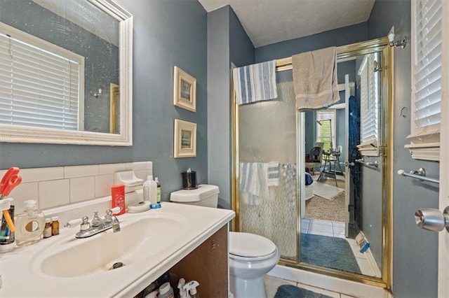 full bath with tile patterned floors, a stall shower, vanity, and toilet