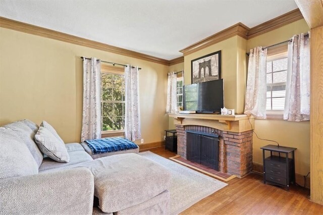 2717 Faraon St, Saint Joseph, MO 64501 - living area featuring crown molding, wood finished floors, baseboards, and a fireplace