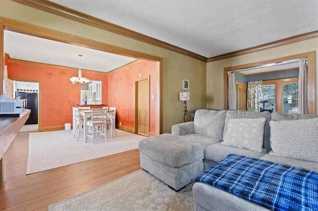 2717 Faraon St, Saint Joseph, MO 64501 - living area featuring a chandelier, wood finished floors, ornamental molding, and baseboards