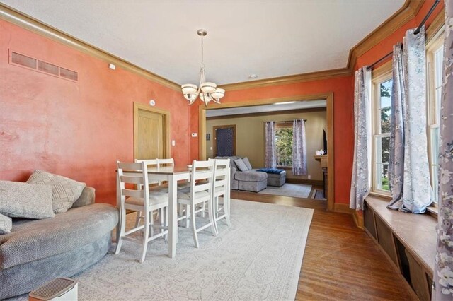 2717 Faraon St, Saint Joseph, MO 64501 - dining room featuring a chandelier, crown molding, wood finished floors, and baseboards