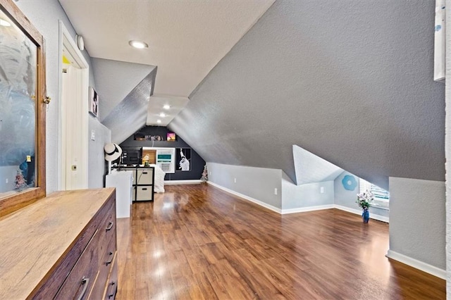 2717 Faraon St, Saint Joseph, MO 64501 - additional living space with vaulted ceiling, wood finished floors, a textured ceiling, and baseboards