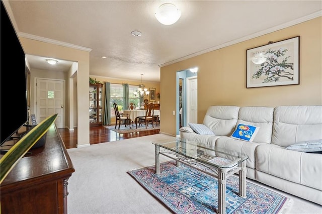 2106 Kasold Dr, Lawrence, KS 66047 - living area with baseboards, ornamental molding, carpet, and a chandelier