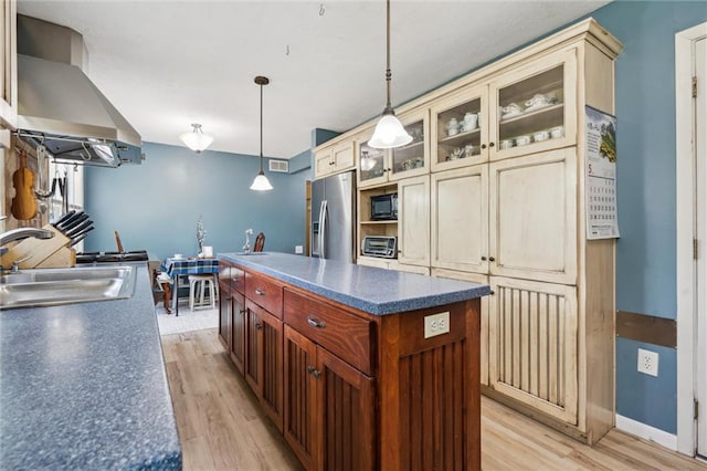2106 Kasold Dr, Lawrence, KS 66047 - kitchen with wall chimney range hood, dark countertops, black microwave, a sink, and stainless steel refrigerator with ice dispenser
