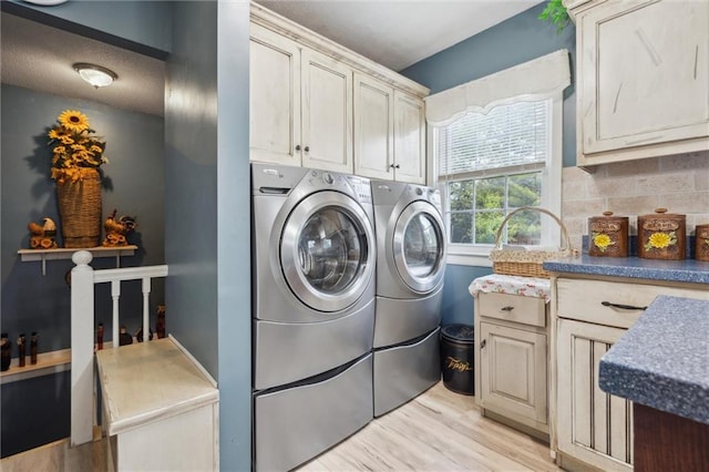 2106 Kasold Dr, Lawrence, KS 66047 - clothes washing area with cabinet space, washing machine and dryer, and light wood-style floors