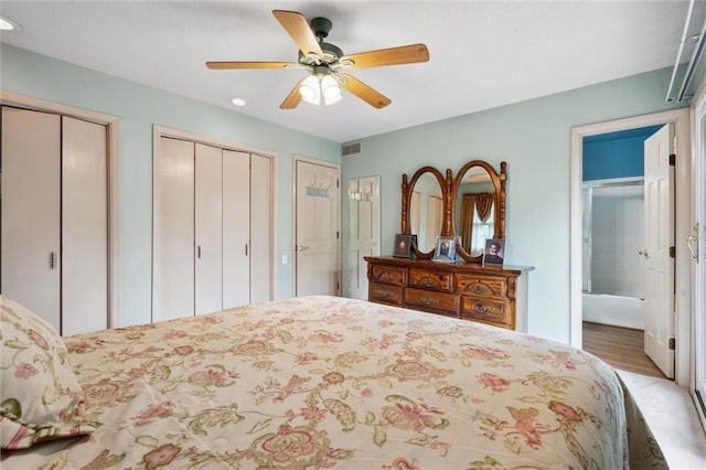 2106 Kasold Dr, Lawrence, KS 66047 - bedroom featuring a ceiling fan, recessed lighting, ensuite bathroom, wood finished floors, and multiple closets