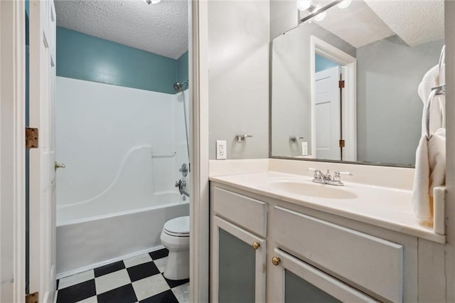2106 Kasold Dr, Lawrence, KS 66047 - full bathroom featuring a textured ceiling, shower / washtub combination, tile patterned floors, vanity, and toilet