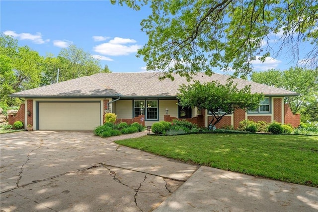 2106 Kasold Dr, Lawrence, KS 66047 - single story home with brick siding, a garage, driveway, and a front yard