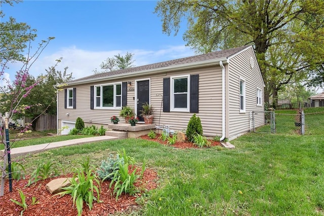 view of front of home with fence and a front lawn