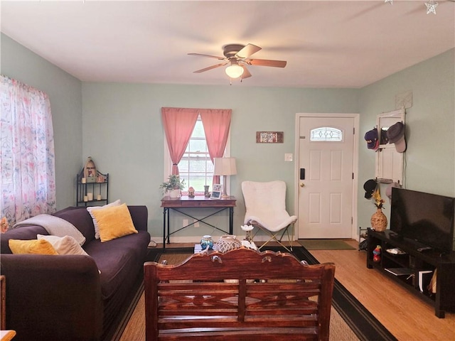 living room with ceiling fan and wood finished floors
