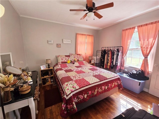 bedroom featuring ceiling fan, ornamental molding, and wood finished floors