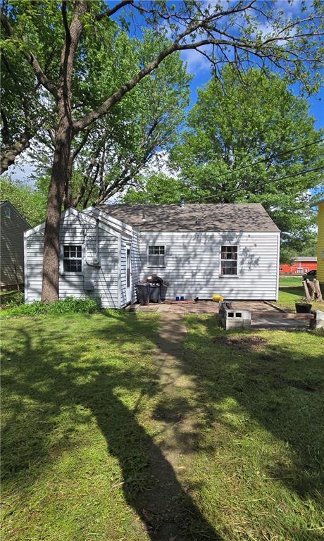 back of property with a yard