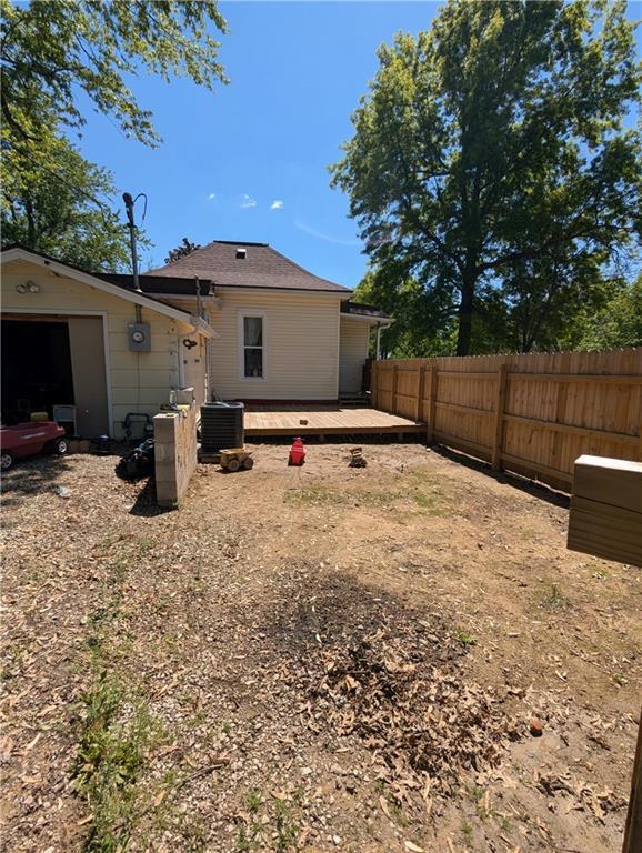 100 E 11th St, Horton, KS 66439 - view of yard featuring central AC unit and fence