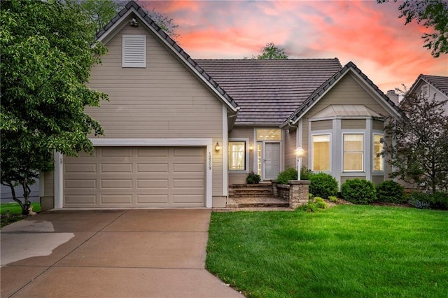 traditional-style home featuring driveway and a lawn