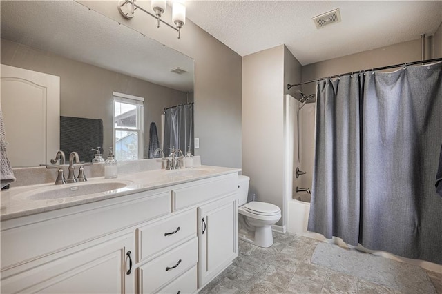 full bath with toilet, double vanity, shower / bath combo with shower curtain, and a textured ceiling
