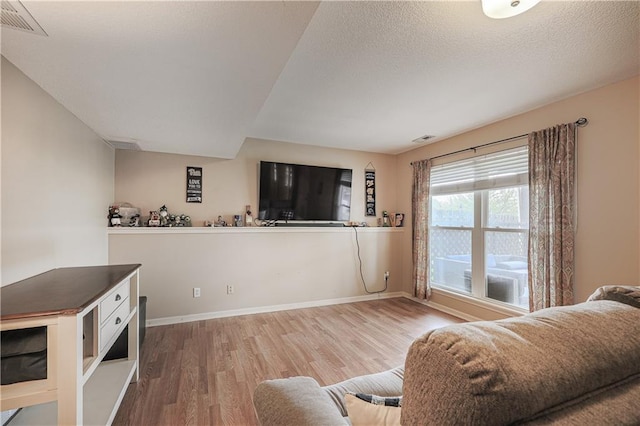 living room with wood finished floors and baseboards