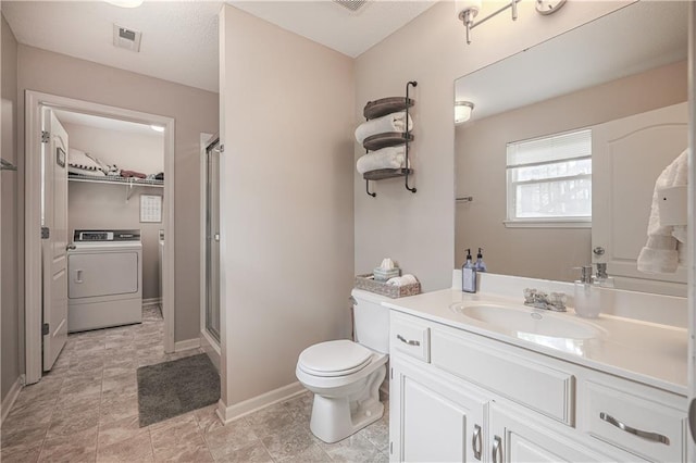full bath with washer / dryer, a stall shower, vanity, toilet, and baseboards