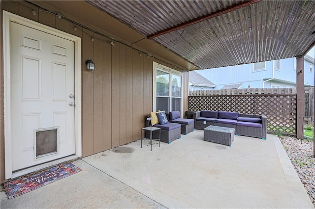 view of patio with an outdoor living space and fence