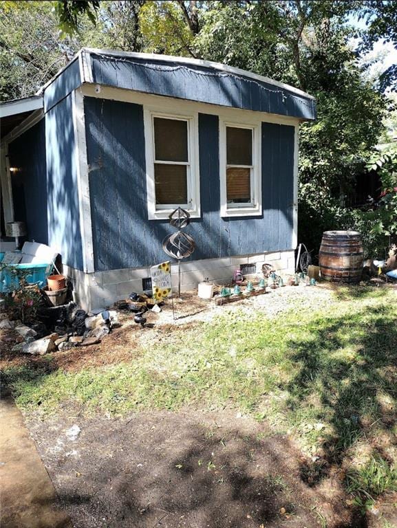 view of property exterior with a lawn and crawl space