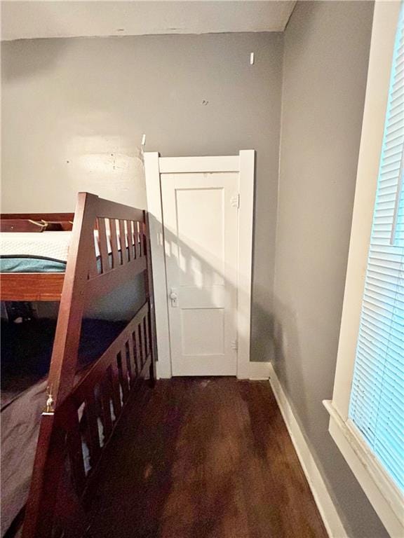 unfurnished bedroom featuring baseboards and wood finished floors