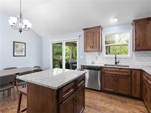 5084 NW Timberline Dr, Riverside, MO 64150 - kitchen featuring decorative backsplash, dishwasher, a sink, lofted ceiling, and an inviting chandelier