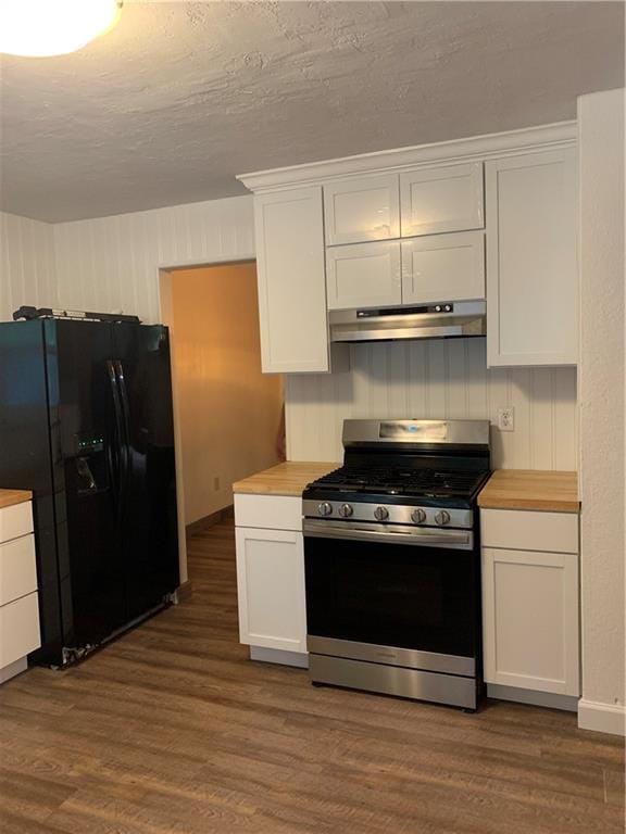 308 NW Shamrock Ave, Lees Summit, MO 64081 - kitchen featuring stainless steel gas range oven, under cabinet range hood, black fridge with ice dispenser, dark wood-type flooring, and white cabinetry