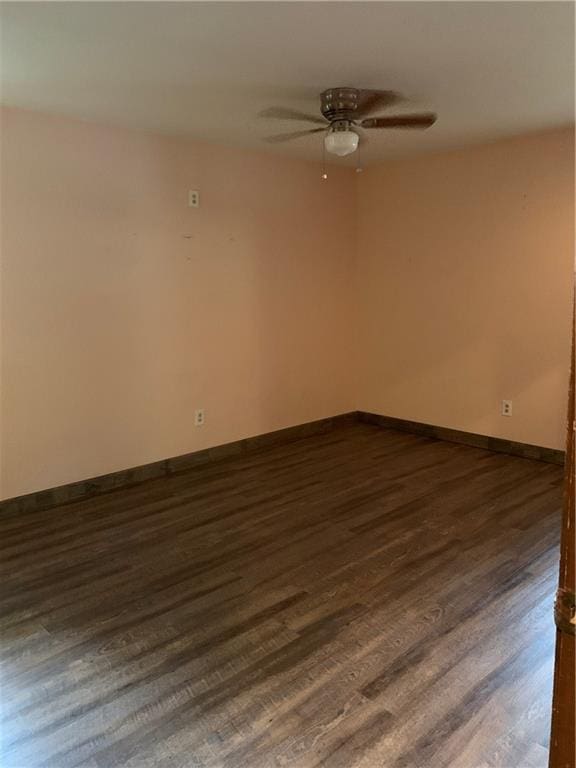 308 NW Shamrock Ave, Lees Summit, MO 64081 - unfurnished room featuring ceiling fan, dark wood-type flooring, and baseboards