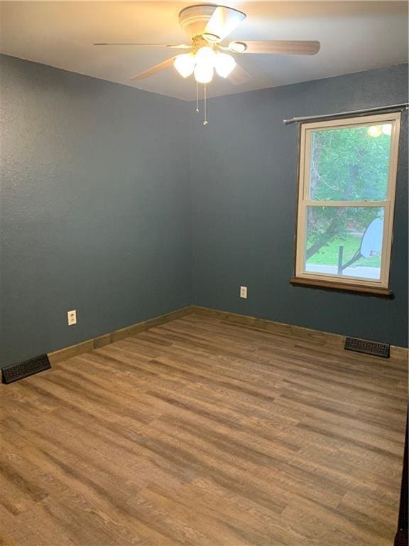 308 NW Shamrock Ave, Lees Summit, MO 64081 - spare room featuring ceiling fan, wood finished floors, and baseboards