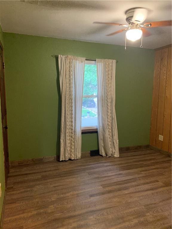 308 NW Shamrock Ave, Lees Summit, MO 64081 - unfurnished room featuring wood finished floors, baseboards, and ceiling fan