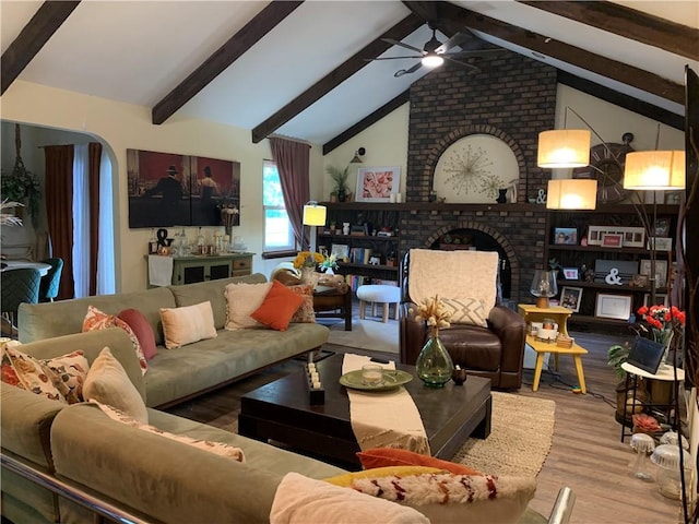 308 NW Shamrock Ave, Lees Summit, MO 64081 - living room with wood finished floors, a ceiling fan, and a fireplace
